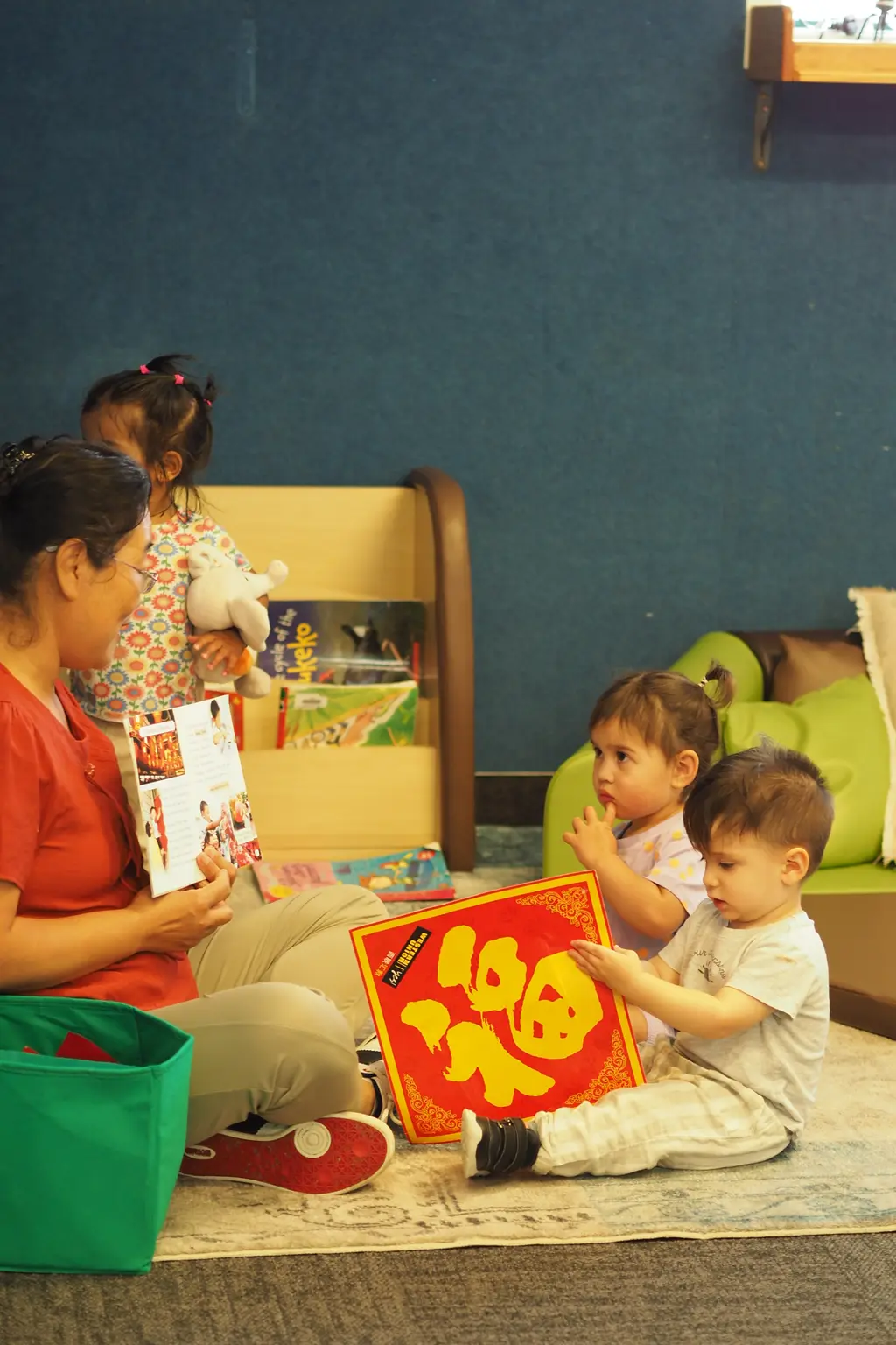 Children and a teacher gathered for indoor play