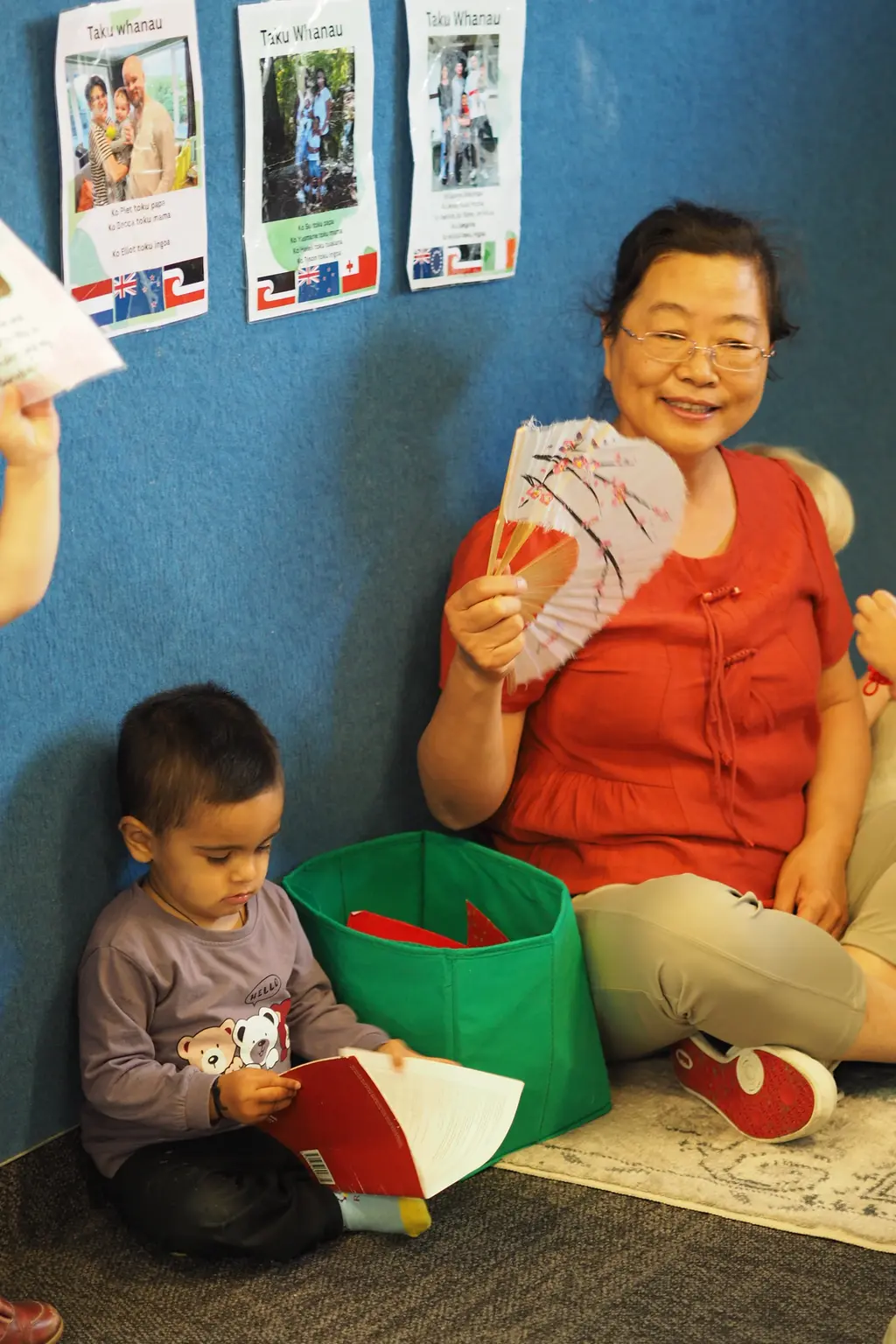 Teacher and children engaged in floor-based learning