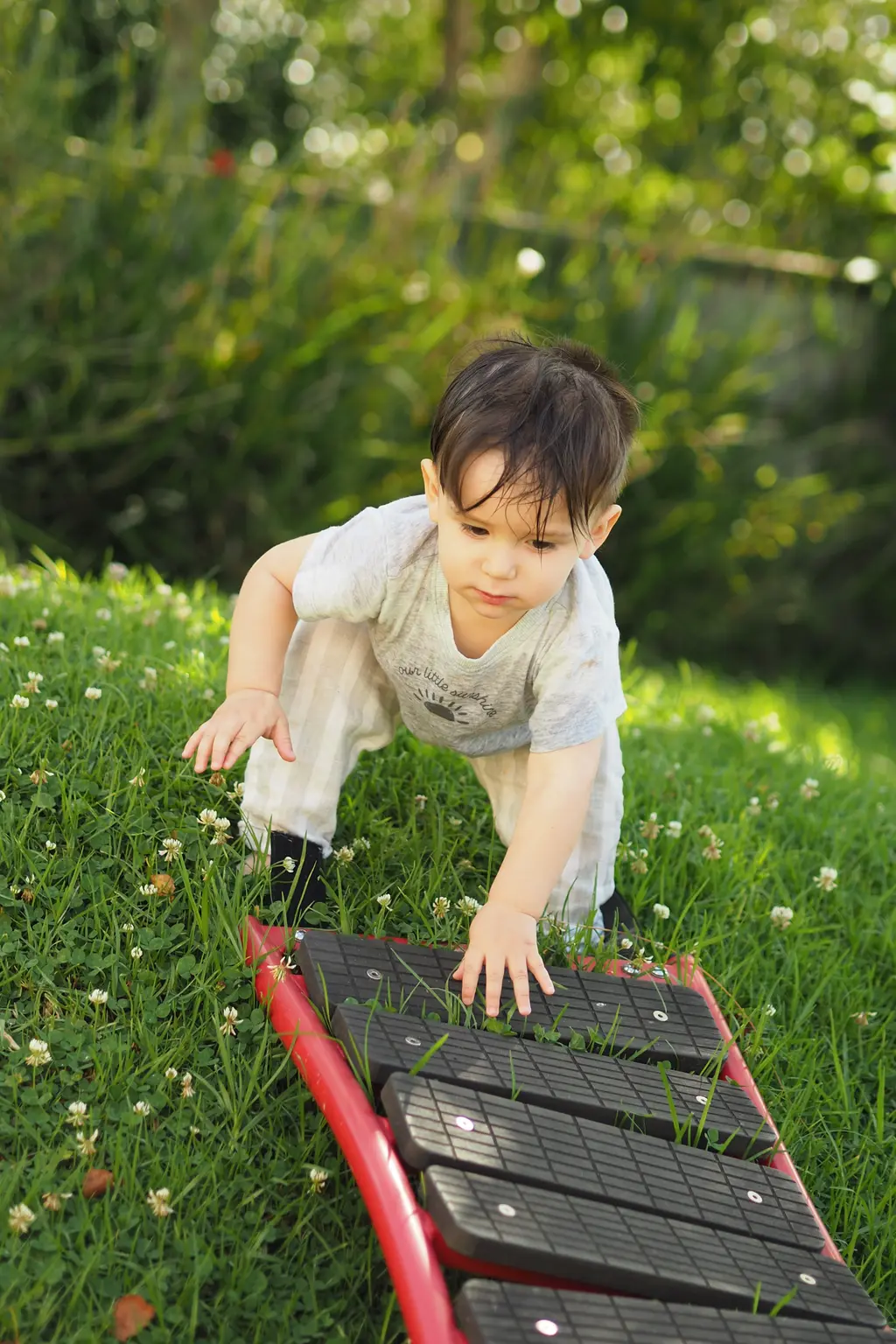 Child playing outdoors on climbing equipment