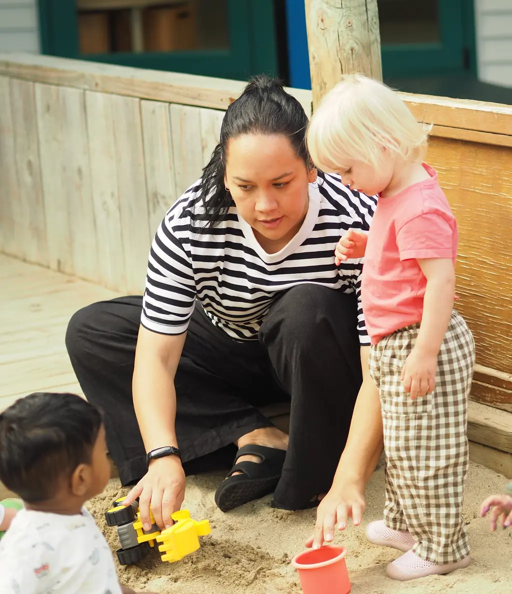 Teacher and child gardening together