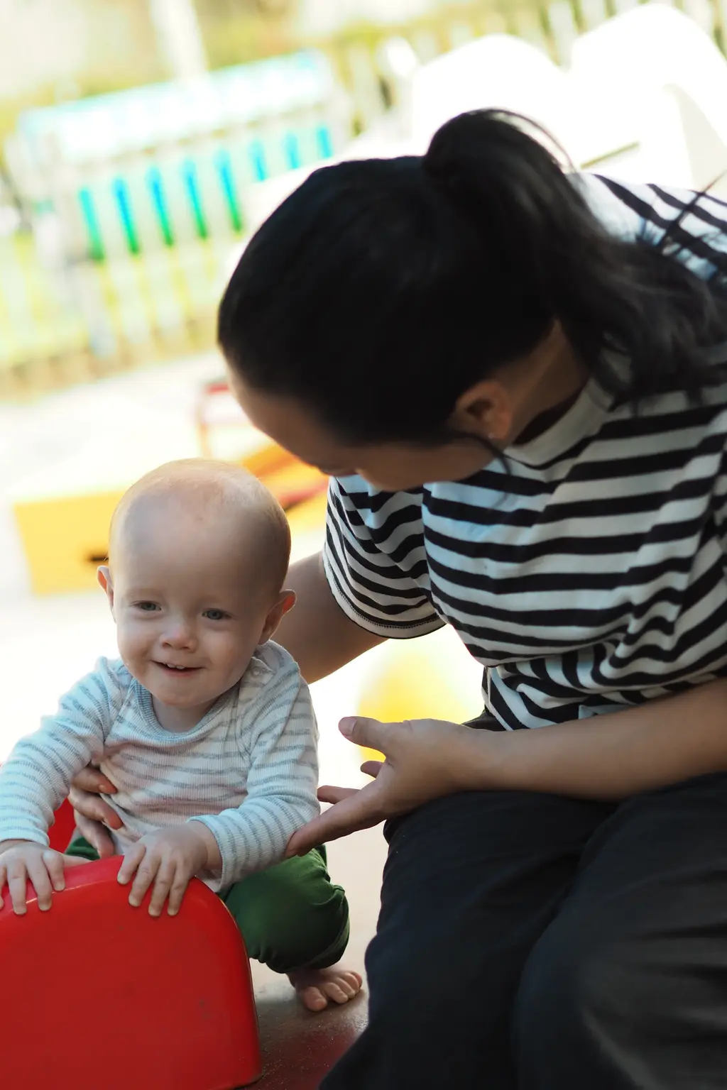 Teacher supporting infant play