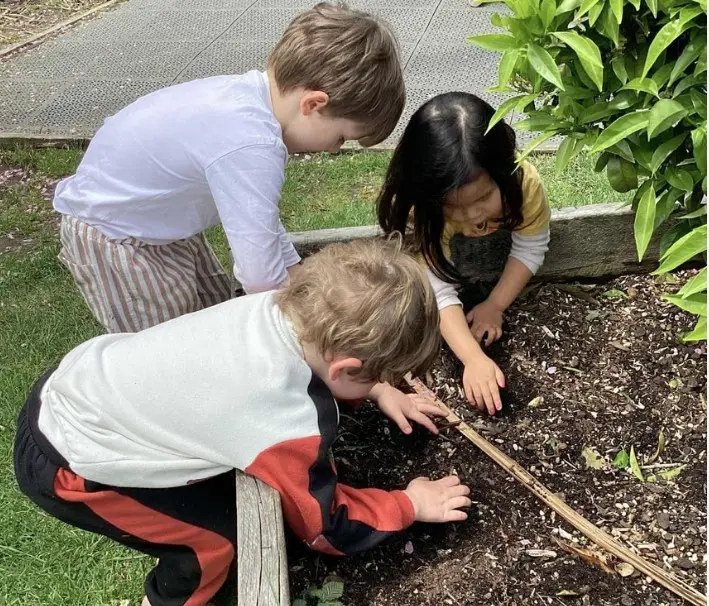 Child drawing on a classroom wall art surface