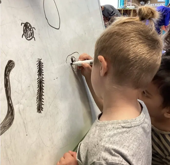 Infant exploring music with a drum